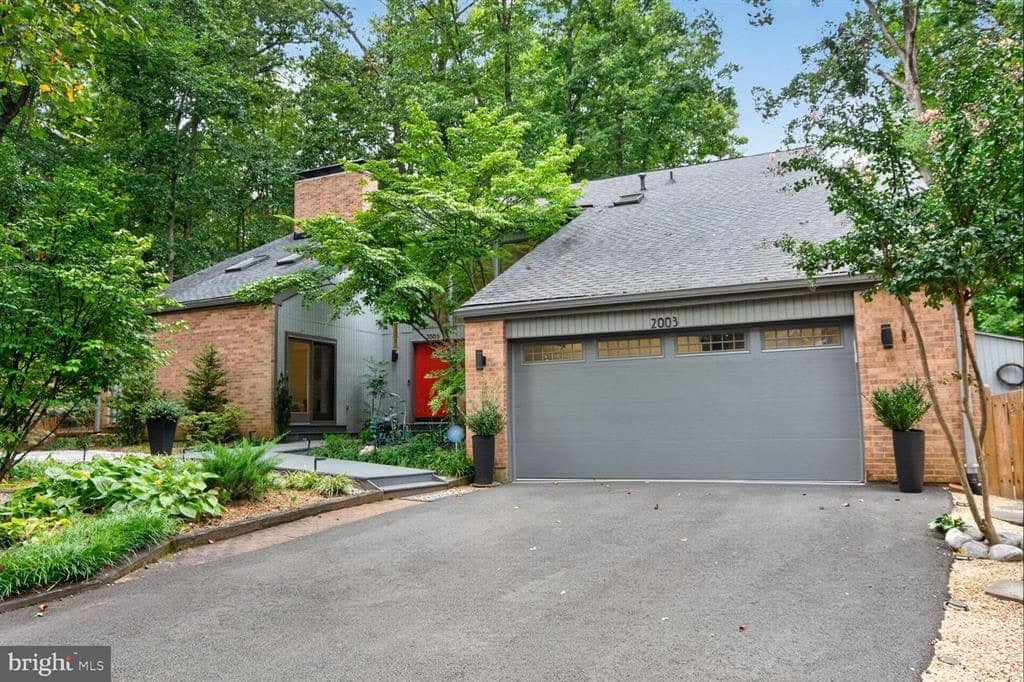 Contemporary front exterior with brick accents and two-car garage at 2003 Upper Lake Drive